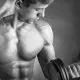 A man lifting dumbbells and flexing his biceps.