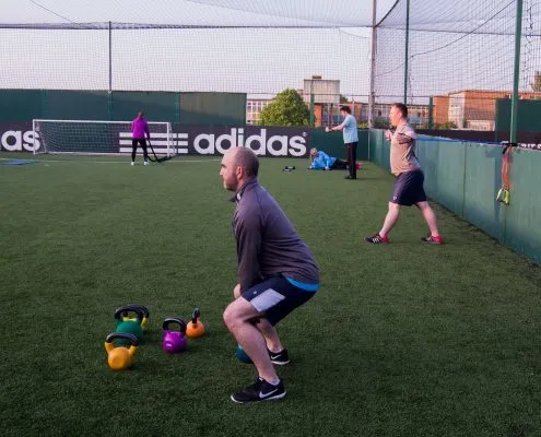 A group of clients from TPTS fitness club being instructed at boot camp fitness classes Swansea by Darren Wilce, Owner of the gym and personal training.
